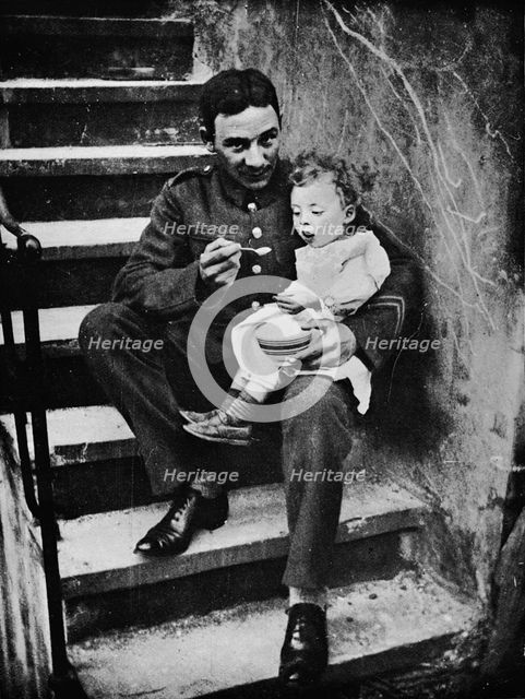 'One of the New Army making himself useful in his billet', 1915. Artist: Unknown.