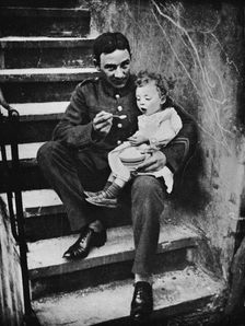 One of the New Army making himself useful in his billet 1915