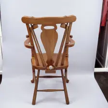 Oak chair carved with a golfing theme, 1920s. Creator: Unknown