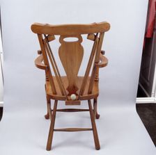 Oak chair carved with a golfing theme, 1920s. Creator: Unknown