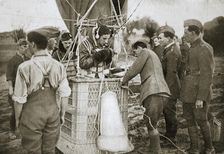 Observer of a kite-balloon testing the telephone before ascending, France, World War I,1916