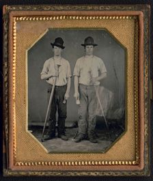 Occupational portrait of two men, standing full length holding floor rammers..., ca. 1850. Creator: Unknown