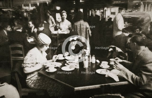 Office workers lunching in a restaurant, New York, USA, early 1930s. Creator: Unknown.