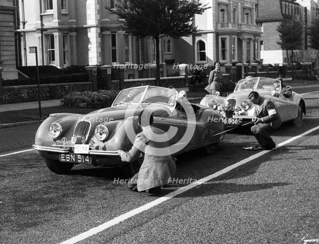 Officials measuring Jaguar XK120, 8 clubs rally Eastbourne 1952. Reg EBN 514. Creator: Unknown.