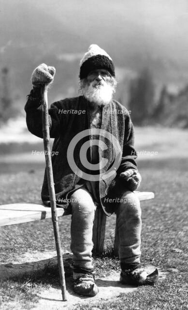 Old man sitting on a bench, Bistrita Valley, Moldavia, north-east Romania, c1920-c1945. Artist: Adolph Chevalier