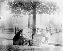Old African-American man selling strawberries on street, Washington, D.C. - two small..., c1900. Creator: Frances Benjamin Johnston