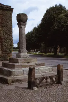 Old cross and stocks in village market square, Ripley, Yorkshire, 20th century. Artist: CM Dixon