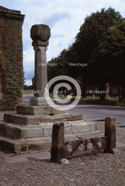 Old cross and stocks in village market square, Ripley, Yorkshire, 20th century. Artist: CM Dixon.