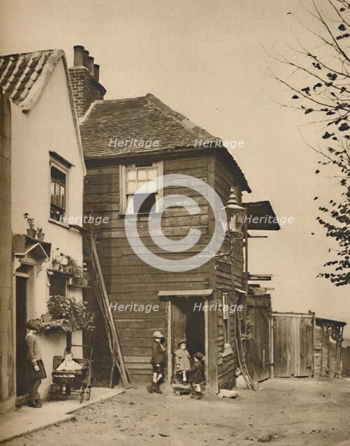'Old Houses in Highgate From Whose Doorways Villagers Watched the Coaches Pass.', c1935. Creator: Unknown.