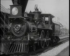 Old Locomotive Travelling Along the Tracks in Front of an Audience of Civilians in a Show..., 1920s. Creator: British Pathe Ltd