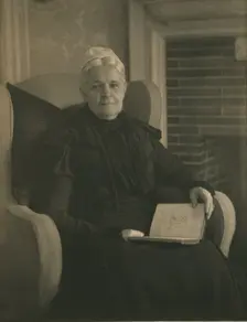 Old woman in an armchair, with an open book in her lap, c1900. Creator: Mathilde Weil