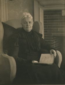 Old woman in an armchair, with an open book in her lap, c1900. Creator: Mathilde Weil