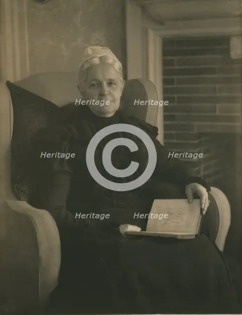 Old woman in an armchair, with an open book in her lap, c1900. Creator: Mathilde Weil.