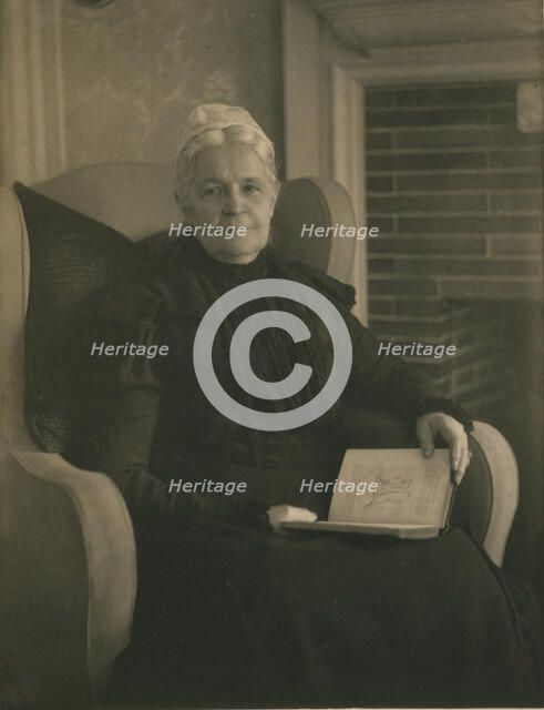 Old woman in an armchair, with an open book in her lap, c1900. Creator: Mathilde Weil.
