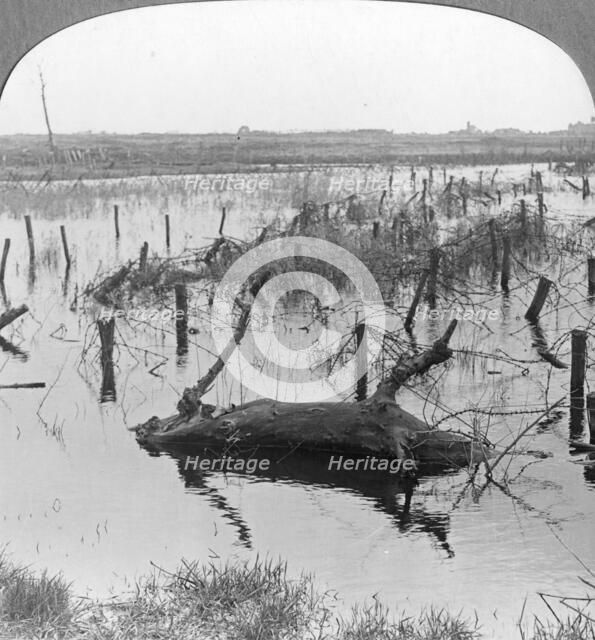 Opened sluices and barbed wire at Nieuwpoort, Belgium, World War I, c1914-c1918. Artist: Realistic Travels Publishers