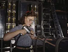 Operating a hand drill at the North American Aviation, Inc., a woman is in the control..., 1942. Creator: Alfred T Palmer