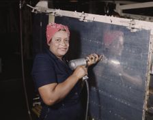 Operating a hand drill at Vultee-Nashville, woman is working on a "Vengeance" dive..., Tenn., 1943. Creator: Alfred T Palmer