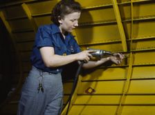 Operating a hand drill at Vultee-Nashville, woman is working on a "Vengeance" dive..., Tenn., 1943. Creator: Alfred T Palmer