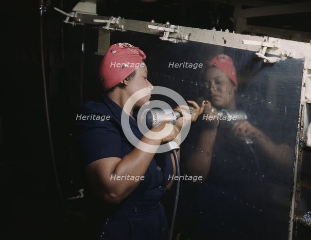 Operating a hand drill at Vultee-Nashville...working on a "Vengeance" dive bomber, Tennessee, 1943. Creator: Alfred T Palmer.