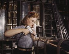 Operating a hand drill at North American Aviation, Inc..., Inglewood, Calif., 1942. Creator: Alfred T Palmer