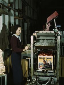 Operating a machine for putting tops on crates, co-op orange packing plant, Redlands, Calif. , 1943. Creator: Jack Delano