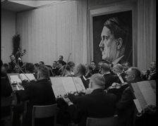 Orchestra Playing with a Portrait of Adolf Hitler in the Background, 1930s. Creator: British Pathe Ltd