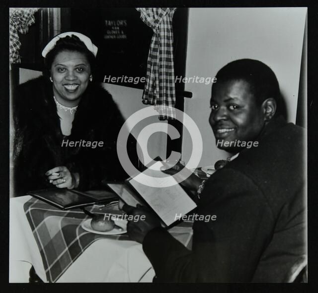 Oscar Peterson looking forward to dinner after a concert at Colston Hall, Bristol, 1955. Artist: Denis Williams