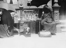 Outside church of St. Jean Baptiste, selling beads, etc., between c1910 and c1915. Creator: Bain News Service