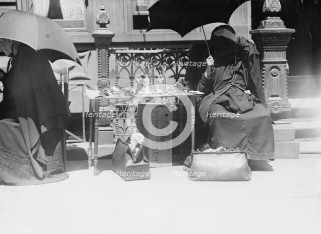 Outside church of St. Jean Baptiste, selling beads, etc., between c1910 and c1915. Creator: Bain News Service.