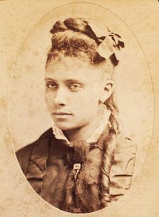 Oval portrait of unidentified young woman with long curl draped over chest. c1880-c1889. Creator: Unknown
