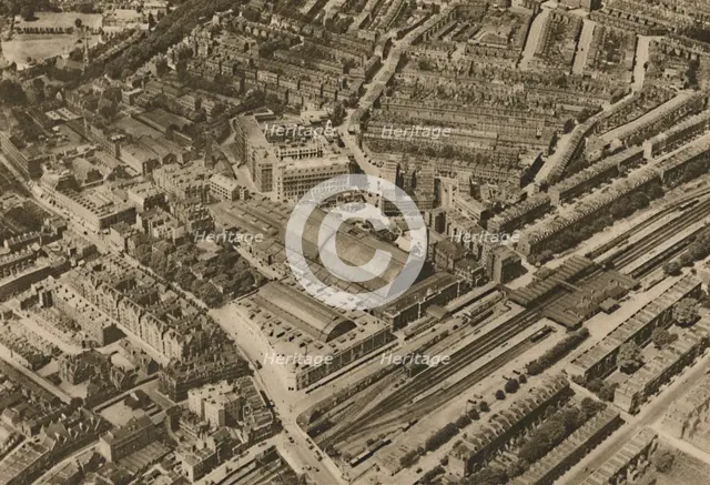 'Over Olympia and the Headquarters of the Post Office Savings Bank', c1935. Creator: Surrey Flying Services.