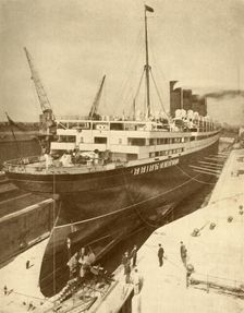 Overhauling a Large Liner in a Graving Dock at Liverpool c1930. Creator: Unknown