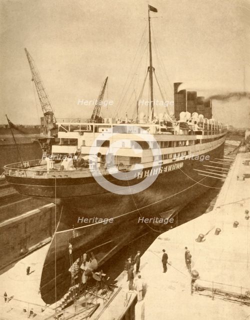 'Overhauling a Large Liner in a Graving Dock at Liverpool', c1930. Creator: Unknown.