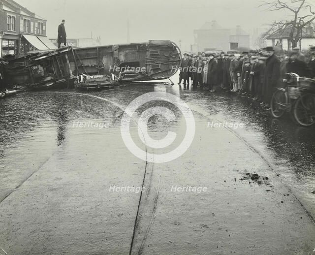 Overturned electric tram and onlookers, London, 1913. Artist: Unknown.
