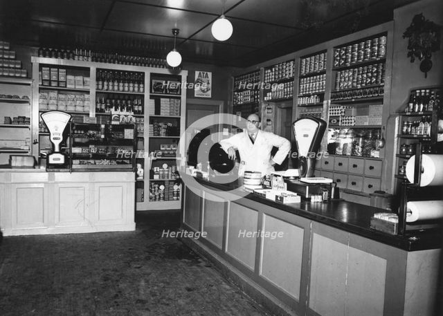 Owner Magnus Påhlsson in his grocer's shop, Sweden, 1943. Creator: Unknown.