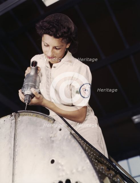 Oyida Peaks riveting as part of her NYA training...Naval Air Base, Corpus Christi, Texas, 1942. Creator: Howard Hollem.