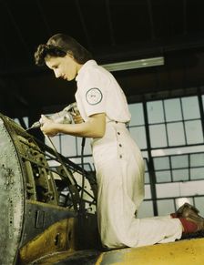 Oyida Peaks riveting as part of her NYA training...Naval Air Base, Corpus Christi, Texas, 1942. Creator: Howard Hollem