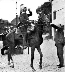 'L'aide Francaise a la Belgique; Un paysan offre a boire a une estafette 1914. Creator: Unknown