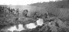 L'avance Francaise; La traversee d'un ruisseau par un groupe cycliste: il existait la un petit pont Creator: Unknown