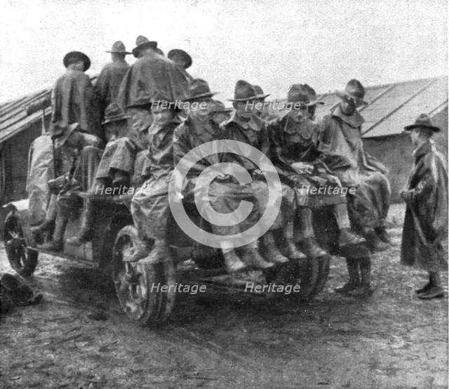 'L'Installation en France de L'Avant-Garde Americaine; Un groupe en manteau de pluie..., 1917. Creator: Unknown.