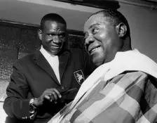 Louis Armstrong having haircut in Hammersmith, London, 1962. Creator: Brian Foskett