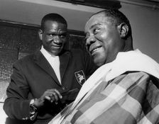 Louis Armstrong having haircut in Hammersmith, London, 1962. Creator: Brian Foskett