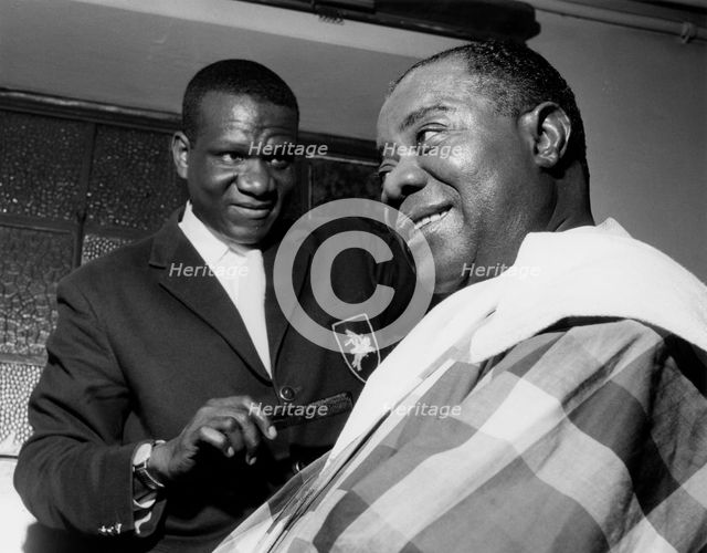 Louis Armstrong having haircut in Hammersmith, London, 1962. Creator: Brian Foskett.