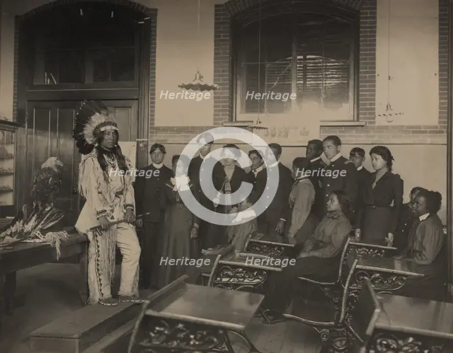 Louis Firetail (Sioux, Crow Creek), wearing tribal clothing, in American history..., 1899 or 1900. Creator: Frances Benjamin Johnston.