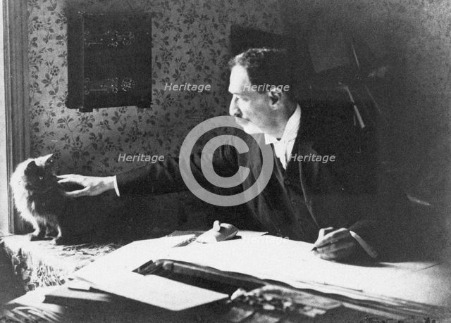 Louis Wain at his drawing board, 1890s. Artist: Anonymous  