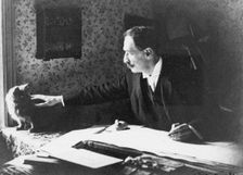 Louis Wain at his drawing board, 1890s. Artist: Anonymous