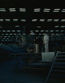 Lowering an engine in place in assembling...Consolidated Aircraft Corp..., Fort Worth, Texas, 1942. Creator: Howard Hollem
