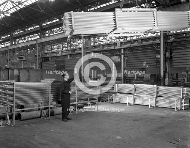 Lowering galvanised heat exchangers, Edgar Allen Steel Co, Sheffield, South Yorkshire, 1964. Artist: Michael Walters