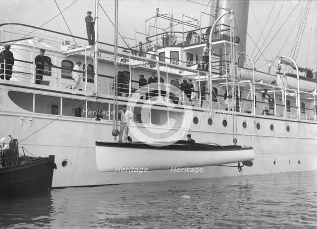 Lowering Liberty's motor launch, 1914. Creator: Kirk & Sons of Cowes.