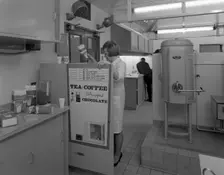 Loading a drinks vending machine at an experimental kitchen in Sheffield, South Yorkshire, 1966. Creator: Michael Walters